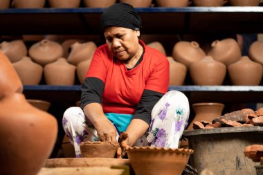 Craftsmen are making jugs or flower pots traditionally on the ronda using clay. : Bantul, Indonesia - 22 December 2022