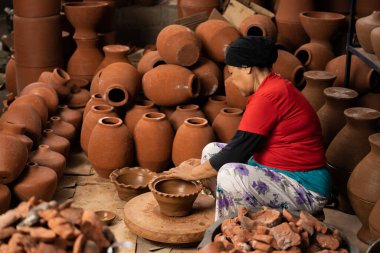 Craftsmen are making jugs or flower pots traditionally on the ronda using clay. : Bantul, Indonesia - 22 December 2022
