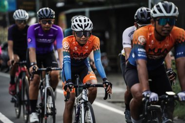 A group of road bike cyclists passed an interesting route in Yogyakarta, in preparation for the Tour de Ambarrukmo. : Yogyakarta - Indonesia, February 11, 2022