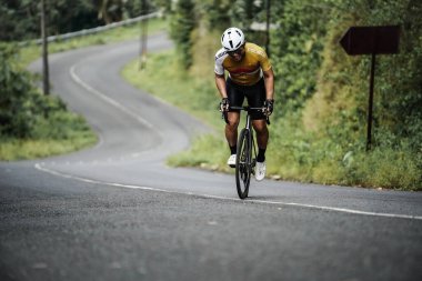 The road bike is going uphill on the cool route of the incline in Panggang area, very aesthetic. Requires great power. : Yogyakarta - Indonesia, February 11, 2022
