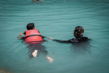 Visitors who swim enjoy the natural attractions of Kedung Pedut, a beautiful natural swimming pool tour. : Kulon progo, Indonesia - 04 May 2022