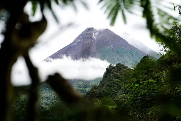 stock image View of Mount Merapi in the morning, and slightly covered by clouds. Potentially eruptive volcano.