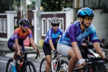 A group of road bike cyclists passed an interesting route in Yogyakarta, in preparation for the Tour de Ambarrukmo. : Yogyakarta - Indonesia, February 11, 2022