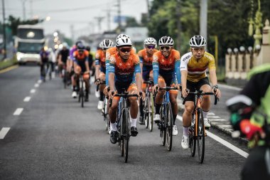 A group of road bike cyclists passed an interesting route in Yogyakarta, in preparation for the Tour de Ambarrukmo. : Yogyakarta - Indonesia, February 11, 2022