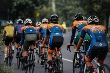 A group of road bike cyclists passed an interesting route in Yogyakarta, in preparation for the Tour de Ambarrukmo. : Yogyakarta - Indonesia, February 11, 2022