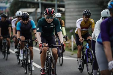 A group of road bike cyclists passed an interesting route in Yogyakarta, in preparation for the Tour de Ambarrukmo. : Yogyakarta - Indonesia, February 11, 2022