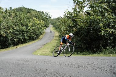 Roadbike riders speed through epic routes in jungle areas. : Yogyakarta - Indonesia, February 11, 2022