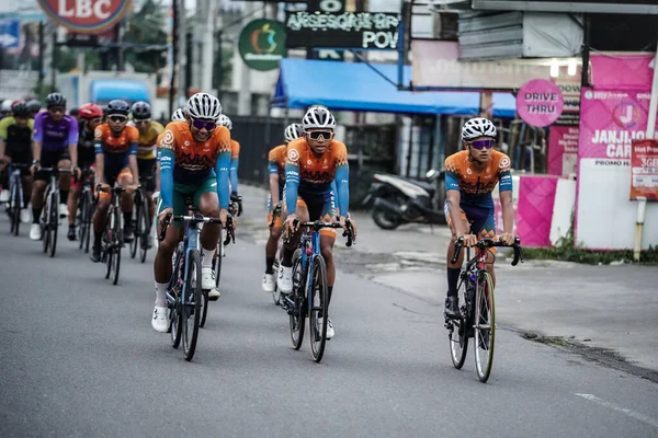 A group of road bike cyclists passed an interesting route in Yogyakarta, in preparation for the Tour de Ambarrukmo. : Yogyakarta - Indonesia, February 11, 2022