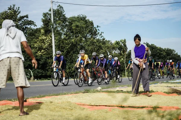A group of road bike cyclists passed an interesting route in Yogyakarta, in preparation for the Tour de Ambarrukmo. : Yogyakarta - Indonesia, February 11, 2022
