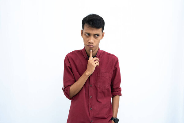 Asian man, business or student concept wearing red casual shirt thinking pose, looking for ideas, getting ideas, confused. Isolated white background.