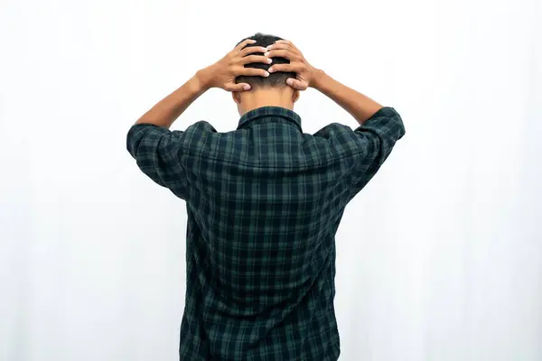 stock image Back view of a man grabbing his head showing stress gesture