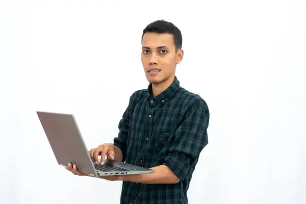 stock image Asian man wearing a green checkered casual shirt is showing a laptop. business photo concept, student. Isolated white background.