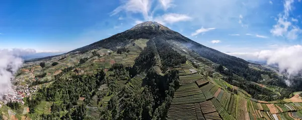 stock image beautiful view of Mount Sumbing when the weather is clear, the sky is blue with a few clouds. Located in Central Java, Indonesia.