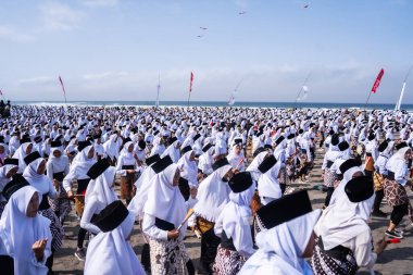 Bantul, Indonesia - 26 August 2023: Indonesian Muri Record, thousands of student dancers in Bantul dance the Montro dance on Depok beach. Montro dance is a sholawat dance art in Bantul. clipart