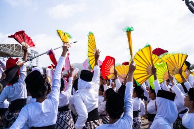 Bantul, Indonesia - 26 August 2023: Indonesian Muri Record, thousands of student dancers in Bantul dance the Montro dance on Depok beach. Montro dance is a sholawat dance art in Bantul. clipart