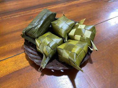 Buras is a typical food of the Bugis and Makassar people. Ketupat made from rice is served on a plate as a complement to typical Makassar food. clipart