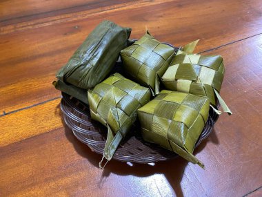 Buras is a typical food of the Bugis and Makassar people. Ketupat made from rice is served on a plate as a complement to typical Makassar food. clipart