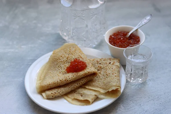 Stock image Crepes, caviar and vodka on a table. Food still life photo. Minimalistic composition still life with sour meal. 