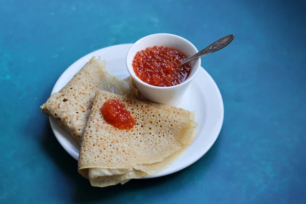 Stock image Tiny pancakes on a plate. Delicious crepes with sour filling. Close up photo of tasty meal. Still life with caviar. Healthy eating concept.  