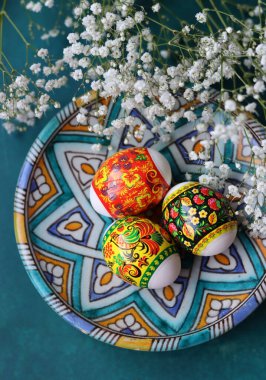 Süslü Paskalya yumurtaları, yakın plan fotoğraf. Hristiyan dini sembolü. Tatiller ve kutlama konsepti. Kopya alanı ile desenli arkaplanda renkli yumurtalar. 