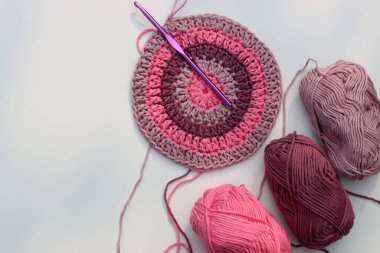 Pembe tığ işi. Organik pembe iplikten yapılmış el yapımı bir süs. Kopyalama alanı olan beyaz arkaplan. Hobi konsepti. 