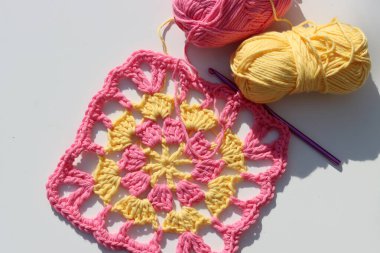 Sarı ve pembe tığ işi. Paskalya tığ işi fikirleri. Yumuşak pamuklu iplik yakın plan fotoğraf. Metin için boşluk olan beyaz arkaplan. 