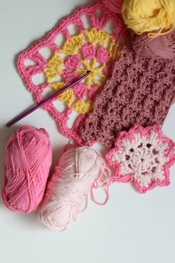 Beyaz arkaplanda farklı örülmüş elementler ve kopyalama alanı. El yapımı ev dekorasyonu. Güzel pembe ve sarı pamuk yumakları. Sanat ve zanaat konsepti. 