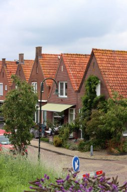 Sokaktaki klasik Hollandalı evleri. Kırmızı kiremitli şirin binalar. Hollanda 'nın mimarisi.. 