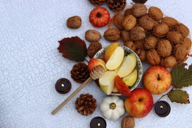 Elmalar, fındıklar, kırmızı yapraklar ve mumlarla dolu bir sonbahar. Metin için alanı olan desenli arkaplan. 
