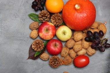 Autumn composition with fruit and leaves on grey background, top view. Healthy eating concept.  clipart