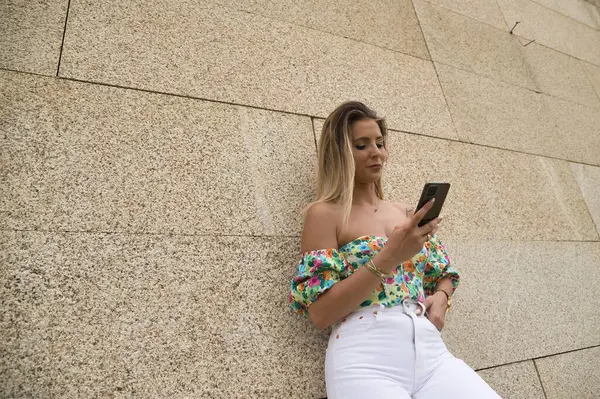 Young Attractive Blonde Woman Flowered Shirt White Pants Checking Social — ストック写真