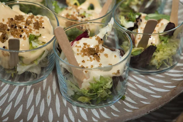 Detail of a glass of quinoa salad with different varieties of lettuce in a catering, Concept food, wedding, menu, catering.