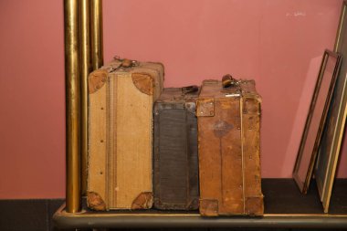Detail of old travel suitcases on the luggage trolley at the reception of a luxurious hotel. Travel concept, rooms, buildings, interior design.