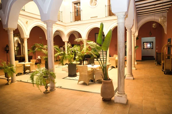 stock image Beautiful interior courtyard with columns and plants of the reception of a luxurious hotel. Travel concept, rooms, buildings, interior design.