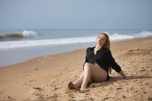 Młoda Kobieta Blondynka Piękna Bikini Czarnej Koszuli Siedzącej Plaży Zrelaksowana Obraz Stockowy