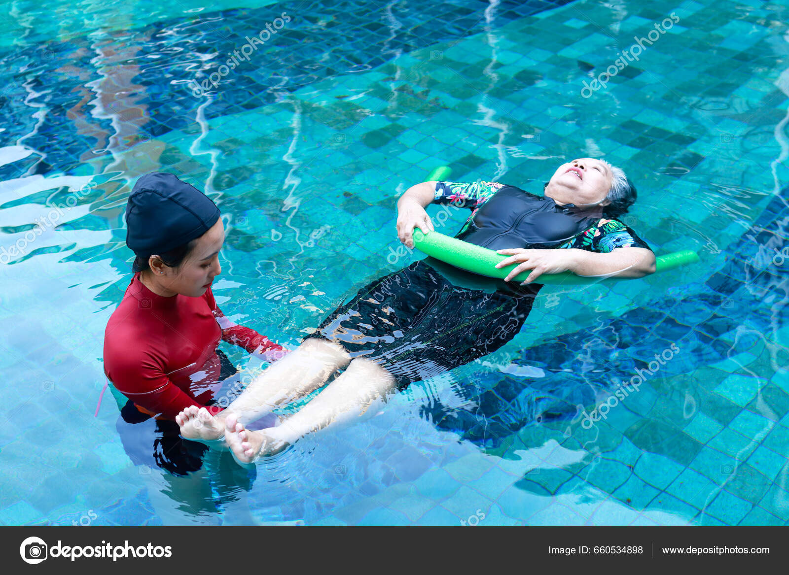 Asian Woman Physiotherapist Helping Elderly Female Patient