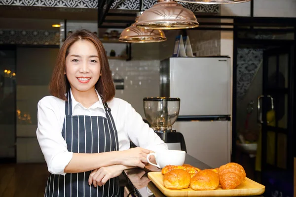 Portrait of an Asian woman running a coffee shop business. Food business concept. SME. Entrepreneurs