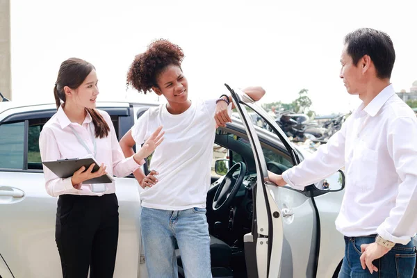 A car insurance company officer holding a booklet informing the customer of an insurance claim from a car accident. The concept of traffic accidents and insurance.