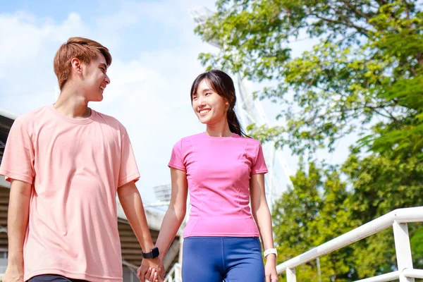 Young Asian couple exercising outdoors together. Sport concept. Healthy exercise.