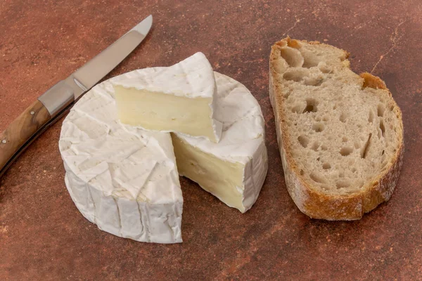 stock image camembert cut on a wooden background