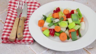 Bir tabak çiğ sebze yakın.