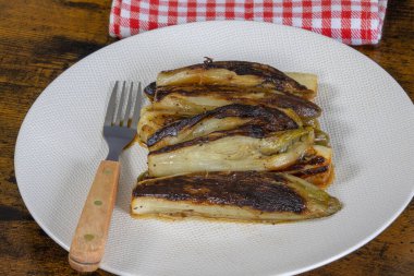 Bir tabak haşlanmış hindiba. Bir masaya yakın plan.