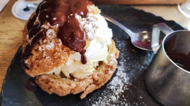 closeup of a profiterole with a chocolate coulis