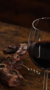 close-up of glass of wine on a wooden background