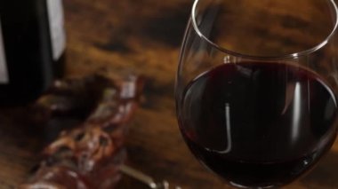 close-up of glass of wine on a wooden background