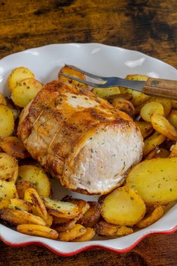 roast pork and sarladaise potatoes in a dish