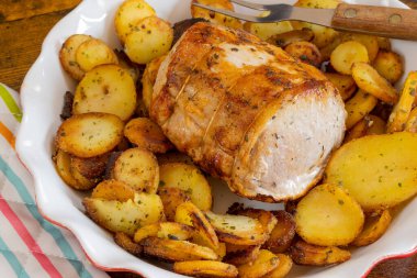 roast pork and sarladaise potatoes in a dish