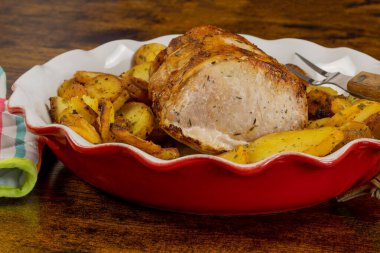 roast pork and sarladaise potatoes in a dish