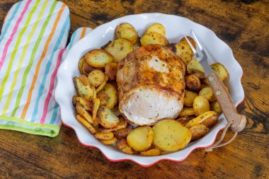 roast pork and sarladaise potatoes in a dish
