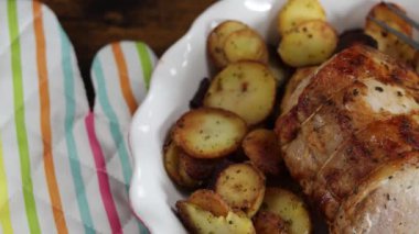 roast pork and sarladaise potatoes in a dish